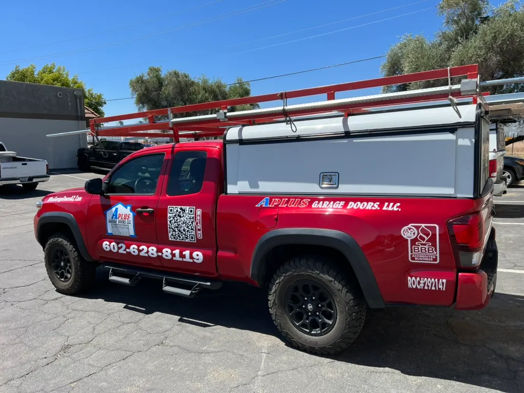 A Plus Garage Doors service truck with ROC license and phone number